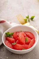 Fresh grapefruit slices in a bowl photo