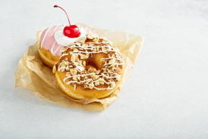 Sweet caramel and cherry glazed donuts photo