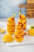 Mangonada mexican mango smoothie with chamoy sauce and lime seasoning photo