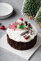 Chocolate Christmas celebration cake with holiday decorations photo