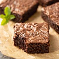 Freshly baked brownies on a parchment paper photo
