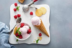 Raspberry ice cream in a bowl and conw with fresh berries photo