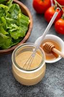 Homemade honey mustard dressing in a glass jar