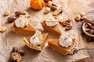 Festive pumpkin pie slices decorated with whipped cream photo