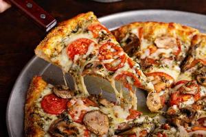 Vegetarian pizza with mushrooms and pesto sauce photo