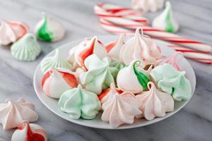 Peppermint meringues on a marble table, Christmas treat photo