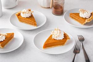Slices of traditional pumpkin pie in a light and bright setting photo