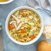 Traditional chicken noodle soup with egg noodles photo