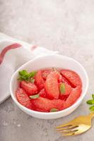 Fresh grapefruit slices in a bowl photo