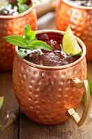 Traditional Moscow Mule in classic copper mugs photo