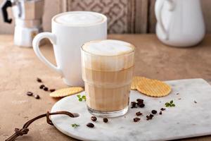 Hot coffee latte and cappuchino in a glass and mug photo