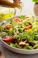 Vegetarian greek salad with vinaigrette dressing photo