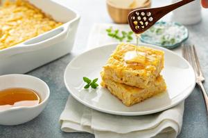 Cheesy cornbread freshly baked served with butter photo