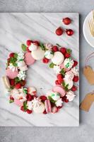 Christmas dessert wreath with macarons and meringues photo