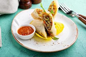 Asian cuisine spring rolls with spicy sauce photo