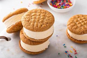 Ice cream and cookies sandwiches stacked on the table photo