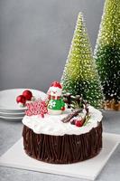 Chocolate Christmas celebration cake with holiday decorations photo