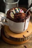 Chocolate cake in a mug with ice cream and sprinkles photo