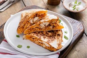 Pulled chicken and cheddar quesadillas on a plate photo
