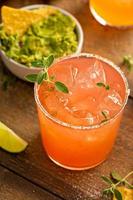 Spicy grapefruit margarita with chips and guacamole photo