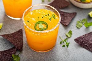 Pineapple and mango margarita with chips and guacamole photo