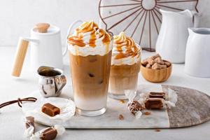 Iced caramel latte topped with whipped cream and caramel sauce photo