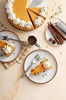 Pumpkin cheesecake with fall spices topped with whipped cream photo