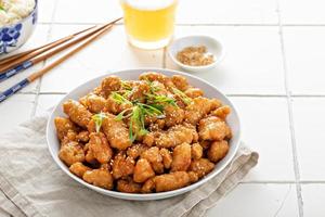 Orange chicken with green onions and sesame seeds photo