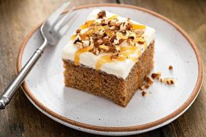 Carrot or pumpkin spiced cake with cream cheese frosting and pecan photo