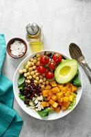 Vegan lunch bowl with chickpeas and roasted squash photo