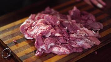 close up of man cut pieces of raw meat video