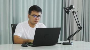 Stressed overwhelmed young businessman in suit working on computer, suffering from eyes fatigue or having painful feelings video