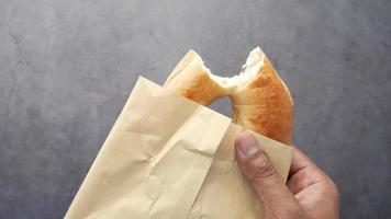 fresh bagel bread in a paper on table video