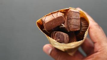 dark chocolate in a paper packet on table video