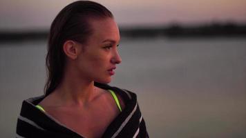 young lady in swimsuit at sunset at the warm evening video