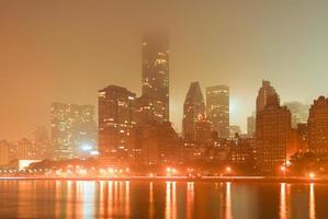 New York City skyline along the east side of Manhattan on a foggy night. photo