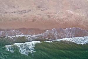 Aerial view of waves crashing on the beach in Brooklyn, New York. photo
