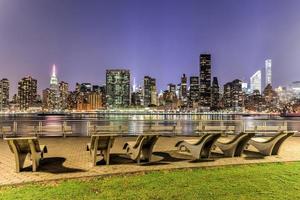 bancos a lo largo del parque gantry con la vista del horizonte de la ciudad de nueva york en el fondo. foto