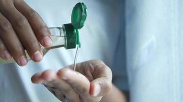 young man pouring hair oil on hand video