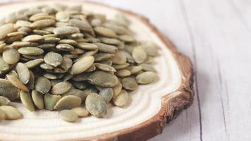 pumpkin seeds in a small bowl on black background video