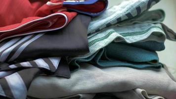 close up of stack of clothes on table video