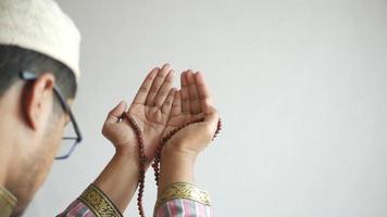 Muslim man keep hand in praying gestures during ramadan, Close up video