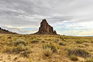 Shiprock is a monadnock rising nearly 1,583 feet above the high-desert plain of the Navajo Nation in San Juan County, New Mexico, United States. photo