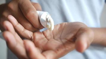 man use cream or lotion onto his hand close up video