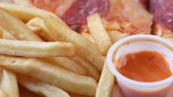 french fries, pizza and sauce on a plate video