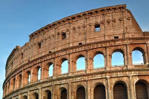 Ancient Roman Colosseum at sunset in Rome, Italy. photo