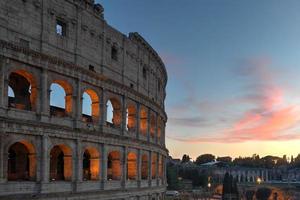 Ancient Roman Colosseum at sunset in Rome, Italy. photo