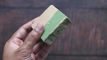 Homemade natural soap bar on black background video