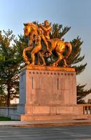Washington, DC - Apr 4, 2021 -  Arts of War, bronze, fire-gilded statue groups on Lincoln Memorial Circle in West Potomac Park at sunset in Washington, DC photo