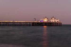 Malibu, California - Aug 27, 2020 -  Malibu Pier along Malibu Beach at sunset in Malibu, California. photo